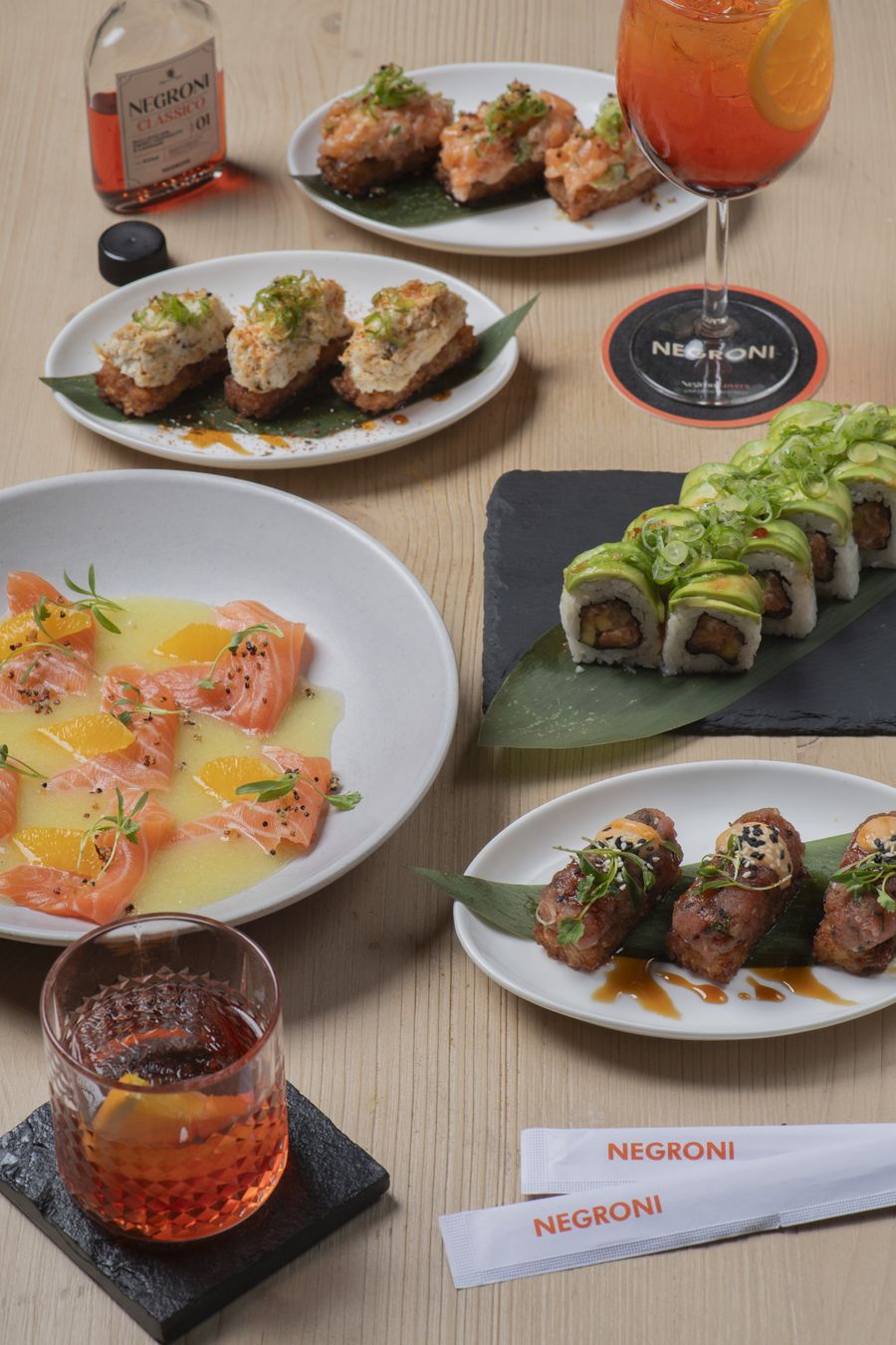 Sushi rolls, tiradito and crispy rice spread